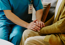 health worker holding a woman's hand